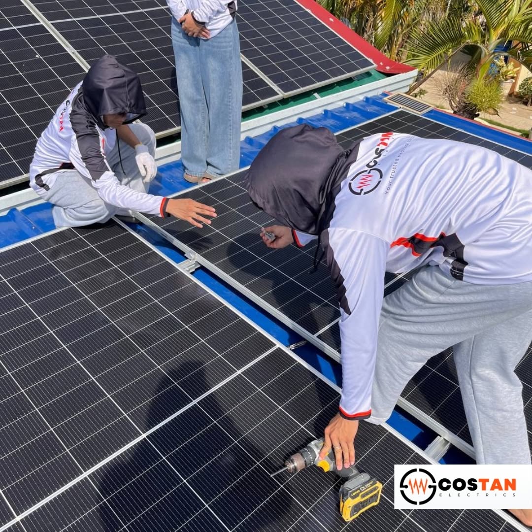Costan Electrics technicians securing solar panel rails with a cordless drill during a residential solar installation in Getafe, Bohol